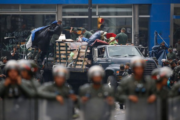 Venezuela's national guard dismantle an anti-government protester's camp site in front of UN offices at Chacao district in Caracas