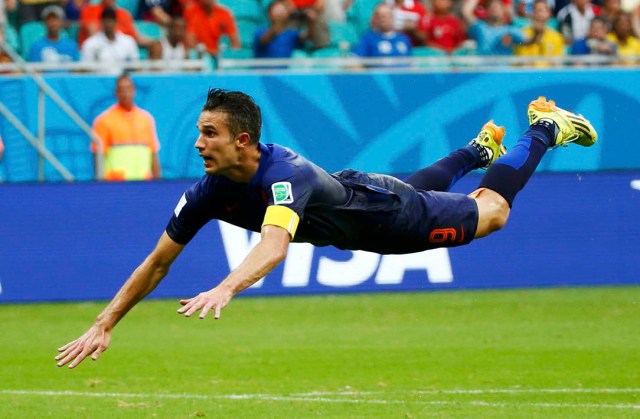 Robin van Persie of the Netherlands heads to score against Spain during their 2014 World Cup Group B soccer match at the Fonte Nova arena in Salvador