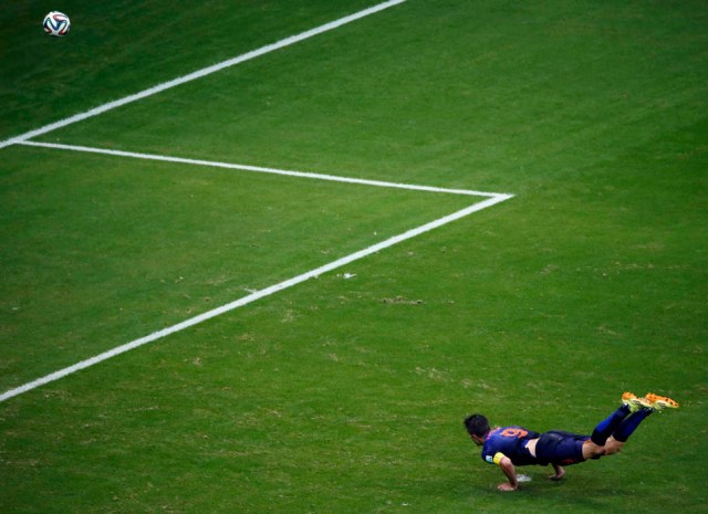 Robin van Persie of the Netherlands heads to score against Spain during their 2014 World Cup Group B soccer match at the Fonte Nova arena in Salvador