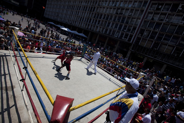 Children exchange punches during their fight in a Olympics-style street boxing championships in Caracas