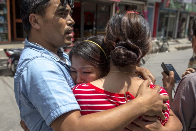 Local residents comfort each others during an earthquake in central Kathmandu