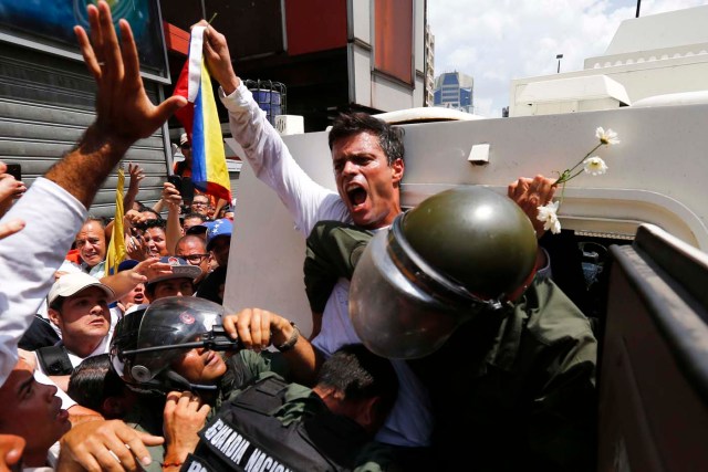 Venezuelan opposition leader Leopoldo Lopez gets into a National Guard armored vehicle in Caracas