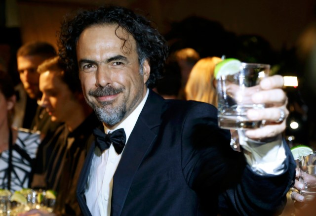 Director Alejandro Gonzalez Inarritu toasts after winning the Oscar for best picture, best director and best original screenplay at the Governors Ball after the 87th Academy Awards in Hollywood