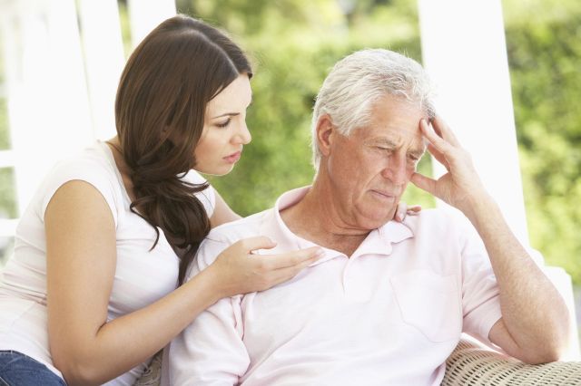 Adult Daughter Talking To Depressed Senior Father