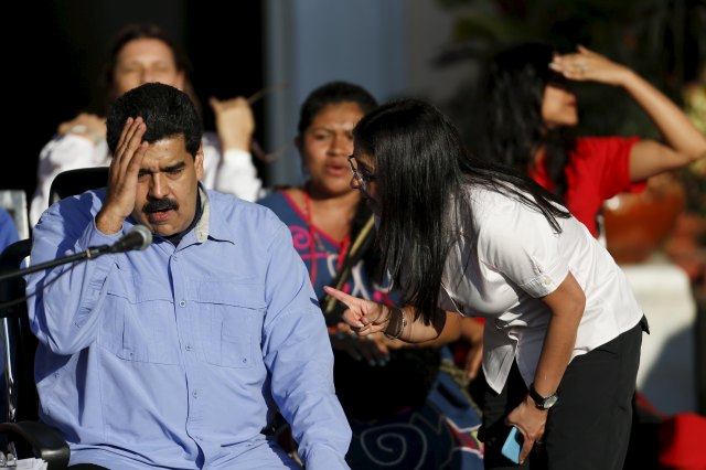 Venezuela's President Nicolas Maduro (L) gestures while he speaks with Venezuela's Foreign Minister Delcy Rodriguez, during a meeting marking International Women's Day, at Miraflores Palace in Caracas March 8, 2016. REUTERS/Carlos Garcia Rawlins