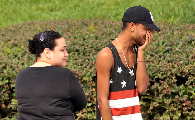 Friends and family members embrace outside the Orlando Police Headquarters during the investigation of a shooting at the Pulse nightclub, where people were killed by a gunman, in Orlando, Florida, U.S June 12, 2016.  REUTERS/Steve Nesius