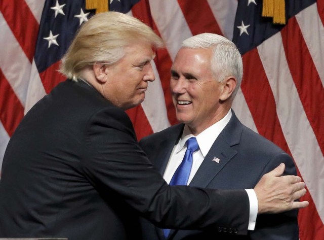 Republican U.S.presidential candidate Donald Trump (L) embraces Indiana Governor Mike Pence after introducing Pence as his vice presidential running mate in New York City, U.S., July 16, 2016. REUTERS/Brendan McDermid