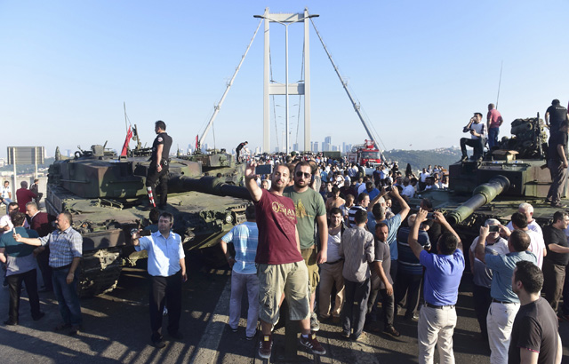 People take selfies after soldiers involved in the coup surrendered on the Bosphorus Bridge in Istanbul, Turkey July 16, 2016. REUTERS/Yagiz Karahan TPX IMAGES OF THE DAY