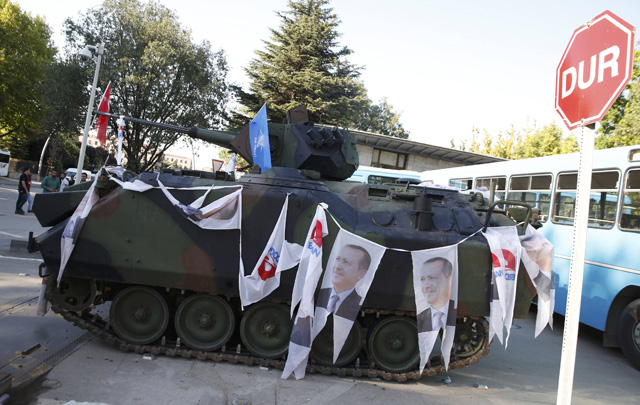 An Armored Vehicle with portraits of Turkish President Tayyip Erdogan is parked outside the parliament building in Ankara, Turkey, July 16, 2016. REUTERS/Baz Ratner