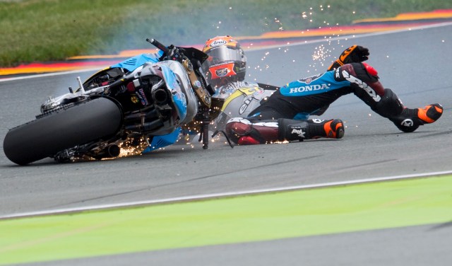 Estrella Galicia 0,0 Marc VDS's Spanish rider Tito Rabat falls during the second training session of the Moto GP of the Grand Prix of Germany at the Sachsenring Circuit on July 15, 2016 in Hohenstein-Ernstthal, eastern Germany.  / AFP PHOTO / Robert MICHAEL