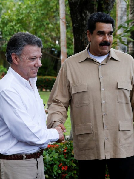Venezuela's President Nicolas Maduro and Colombia's President Juan Manuel Santos shake hands during their meeting at Macagua Hydroelectric compound in Puerto Ordaz
