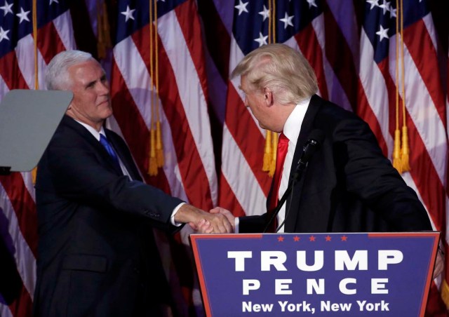 U.S. President-elect Donald Trump greets his running mate Mike Pence during his election night rally in Manhattan, New York, U.S., November 9, 2016.    REUTERS/Mike Segar