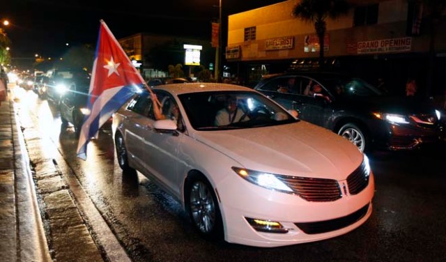 A Cuba flag is displayed from a car as Cuban Americans celebrate upon hearing about the death of longtime Cuban leader Fidel Castro in the Little Havana neighborhood of Miami, Florida on November 26, 2016. Cuba's socialist icon and father of his country's revolution Fidel Castro died on November 25 aged 90, after defying the US during a half-century of ironclad rule and surviving the eclipse of global communism. / AFP PHOTO
