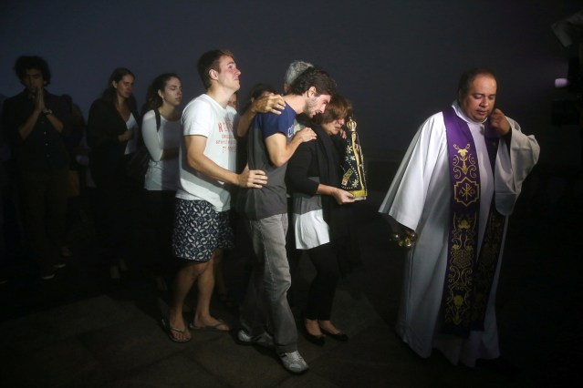 Relatives of Brazilian journalist Guilherme Marques, who died in a plane accident that crashed into Colombian junglewith Brazilian soccer team Chapecoense onboard near Medellin, mourn during a mass in Rio de Janeiro, Brazil, November 29, 2016. REUTERS/Pilar Olivares