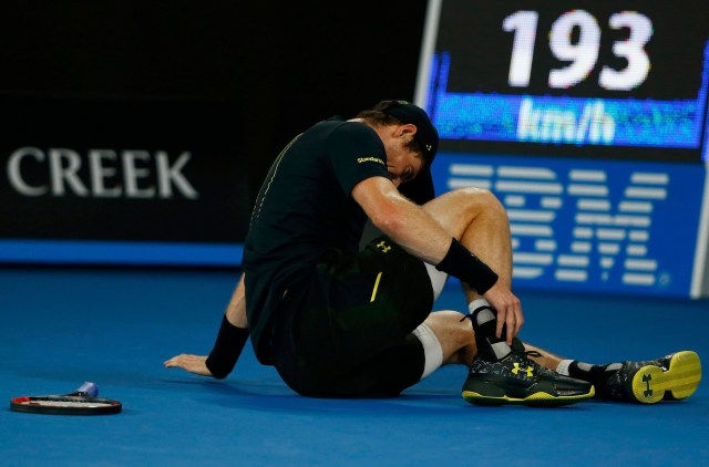 Tennis - Australian Open - Melbourne Park, Melbourne, Australia - 18/1/17 Britain's Andy Murray holds his ankle after falling onto the court during his Men's singles second round match against Russia's Andrey Rublev. REUTERS/Thomas Peter