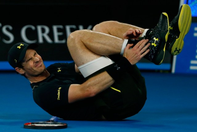 Tennis - Australian Open - Melbourne Park, Melbourne, Australia - 18/1/17 Britain's Andy Murray holds his ankle after falling onto the court during his Men's singles second round match against Russia's Andrey Rublev. REUTERS/Thomas Peter