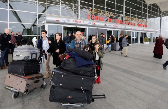 Fuad Sharef Suleman and his family push their belongings after returning to Iraq from Egypt, where they were prevented from boarding a plane to the U.S., following U.S. President Donald Trump's decision to temporarily bar travellers from seven countries, including Iraq, at Erbil International Airport, Iraq, January 29, 2017. REUTERS/Ahmed Saad