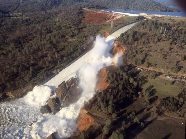 A damaged spillway with eroded hillside is seen in an aerial photo taken over the Oroville Dam in Oroville, California, U.S. February 11, 2017. California Department of Water Resources/William Croyle/Handout via REUTERS ATTENTION EDITORS - THIS IMAGE WAS PROVIDED BY A THIRD PARTY. EDITORIAL USE ONLY. THIS PICTURE WAS PROCESSED BY REUTERS TO ENHANCE QUALITY. AN UNPROCESSED VERSION HAS BEEN PROVIDED SEPARATELY. TPX IMAGES OF THE DAY