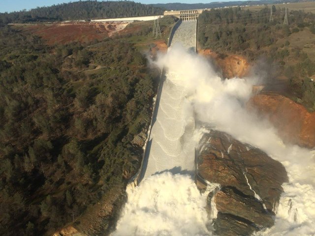 A damaged spillway with eroded hillside is seen in an aerial photo taken over the Oroville Dam in Oroville, California, U.S. February 11, 2017. California Department of Water Resources/William Croyle/Handout via REUTERS ATTENTION EDITORS - THIS IMAGE WAS PROVIDED BY A THIRD PARTY. EDITORIAL USE ONLY.