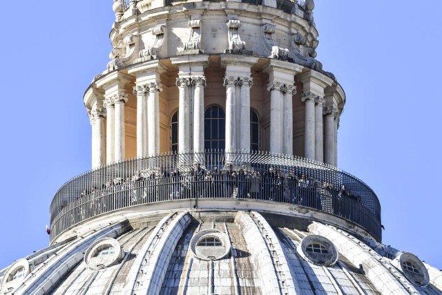 People look from the Dome of St. Peter Basilica as Pope Francis addresses the crowd from the window of the apostolic palace overlooking St. Peter's square during his Angelus prayer on February 19, 2017 in Vatican City. / AFP PHOTO / ANDREAS SOLARO