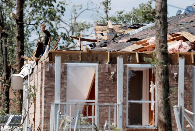 A homeowner takes stock of the damage to his home after a tornado hit the town of Emory, Texas, U.S. April 30, 2017. REUTERS/Brandon Wade