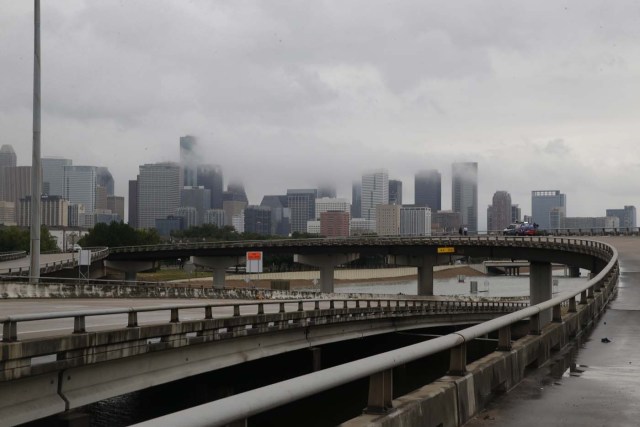 The downtown Houston skyline and flooded highway 288 are seen August 27, 2017 as the city battles with tropical storm Harvey and resulting floods. / AFP PHOTO / Thomas B. Shea