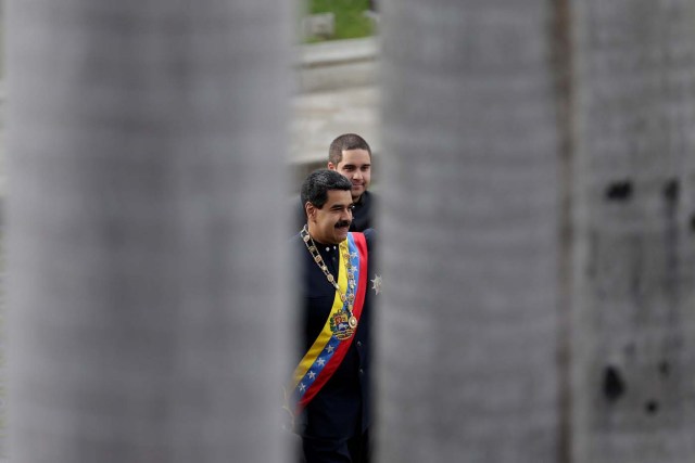 Venezuela's President Nicolas Maduro (bottom) and his son and National Constituent Assembly member Nicolas Maduro Guerra are pictured between palm trees as they arrive for a session of the National Constituent Assembly at Palacio Federal Legislativo in Caracas, Venezuela August 10, 2017. REUTERS/Ueslei Marcelino