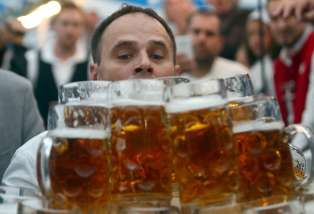 German Oliver Struempfel competes to set a new world record in carrying one liter beer mugs over a distance of 40 m (131 ft 3 in) in Abensberg, Germany September 3, 2017. Struempfel carried 29 mugs over 40 meters to set a new world record. REUTERS/Michael Dalder