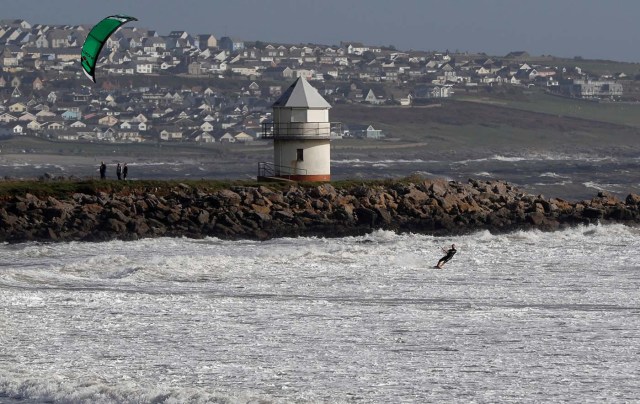 Kitesurfers takes to the sea as storm Ophelia approaches in Porthcawl, Wales, Britain October 16, 2017. REUTERS/Darren Staples