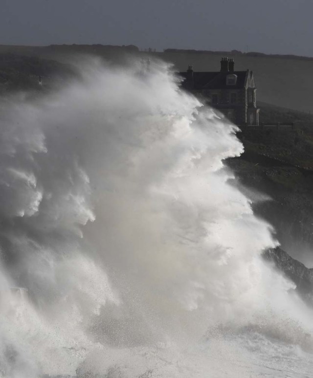 Large waves crash along sea defences and the harbour as storm Ophelia approaches Porthleven in Cornwall, south west Britain, October 16, 2017. REUTERS/Toby Melville