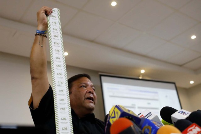 Andres Velasquez, former candidate for governor of Bolivar state, shows an electoral act as he talks to the media during a news conference in Caracas, Venezuela, October 20, 2017. REUTERS/Marco Bello