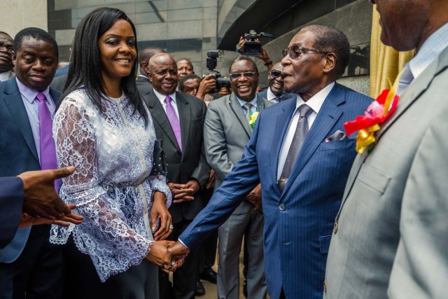 Zimbabwean President Robert Mugabe (R) is congratulated by First Lady Grace Mugabe after he unveiled a plaque at the country's main international airport in Harare, Zimbabwe, renamed after him on November 9, 2017. Zimbabwean President Robert Mugabe attended a ceremony re-naming Harare Airport in his honour on November 9, 2017, as his sacking of the vice president fuelled speculation over his succession plans. The 93-year-old president unveiled a plaque at the newly named Robert Gabriel Mugabe International Airport, located 15 kilometers (nine miles) outside the centre of the capital. The refurbishment of the airport has been condemned by opposition figures as a waste of money. / AFP PHOTO / Jekesai NJIKIZANA
