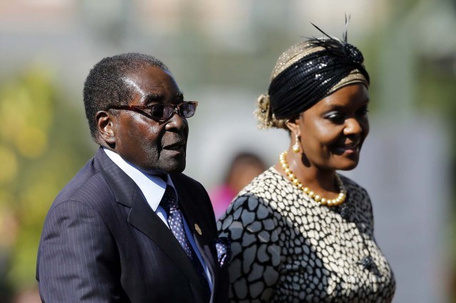 (FILES) This file photo taken on May 24, 2014 shows Zimbabwean President Robert Mugabe (L) arriving with his wife Grace for the inauguration ceremony of South African President Jacob Zuma at the Union Buildings in Pretoria. Zimbabwe's military appeared to be in control of the country on November 15, 2017 as generals denied staging a coup but used state television to vow to target "criminals" close to President Robert Mugabe. Mnangagwa's dismissal left Mugabe's wife Grace, 52, in prime position to succeed her husband as the next president -- a succession strongly opposed by senior ranks in the military. / AFP PHOTO / POOL / SIPHIWE SIBEKO