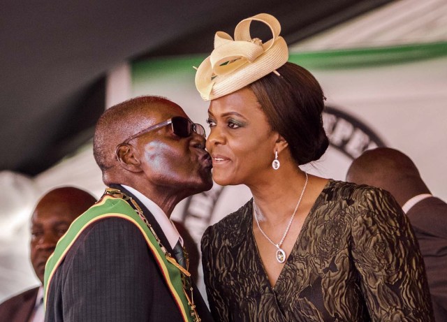 (FILES) This file photo taken on April 18, 2017 shows President Robert Mugabe kissing his wife and first lady Grace Mugabe during during the country's 37th Independence Day celebrations at the National Sports Stadium in Harare. Zimbabwe's military appeared to be in control of the country on November 15, 2017 as generals denied staging a coup but used state television to vow to target "criminals" close to President Robert Mugabe. Mnangagwa's dismissal left Mugabe's wife Grace, 52, in prime position to succeed her husband as the next president -- a succession strongly opposed by senior ranks in the military. / AFP PHOTO / Jekesai NJIKIZANA