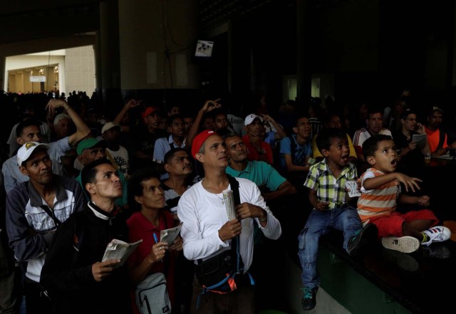 People react as they watch a horse race at La Rinconada Hippodrome, in Caracas, Venezuela, October 14, 2017. REUTERS/Ricardo Moraes SEARCH "MORAES GAMBLING" FOR THIS STORY. SEARCH "WIDER IMAGE" FOR ALL STORIES.