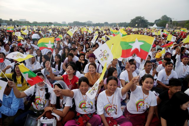Catholic faithful wave Myanmar and Vatican City flags as they attend a mass led by Pope Francis at Kyite Ka San Football Stadium in Yangon, Myanmar November 29, 2017. REUTERS/Max Rossi