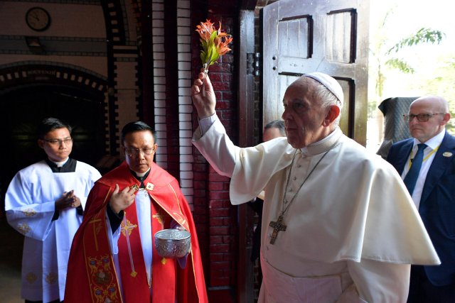 Pope Francis blesses as he arrives to celebrate a Mass with youths at St. Mary's Cathedral, in Yangon, Myanmar November 30, 2017. Osservatore Romano/Handout via Reuters ATTENTION EDITORS - THIS IMAGE WAS PROVIDED BY A THIRD PARTY. EDITORIAL USE ONLY. NO RESALES. NO ARCHIVE.