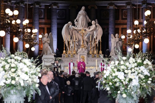 Mgr Benoist De Sinety (C), flanked by French priest Guy Gilbert (L), leads the funeral ceremony for late French singer and actor Johnny Hallyday at the Madeleine Church in Paris, France, December 9, 2017. REUTERS/Ludovic Marin/Pool