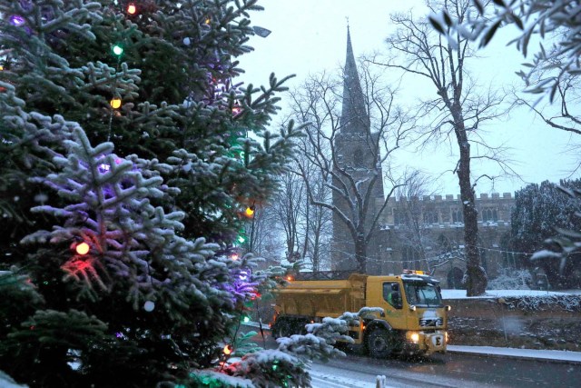 A road gritting vehicle treats the streets as the snow falls in Kegworth, Britain, December 10, 2017. REUTERS/Darren Staples