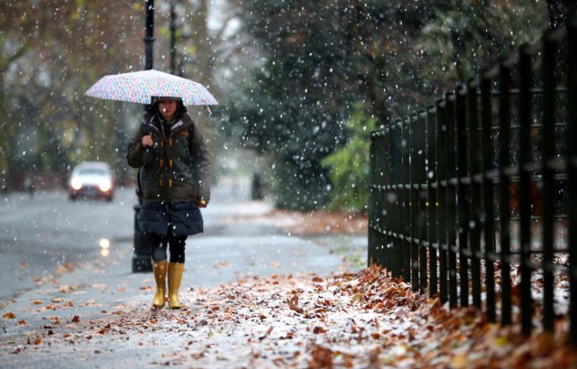 A woman walks through the snow in Battersea Park, London, Britain, December 10, 2017. REUTERS/Hannah McKay