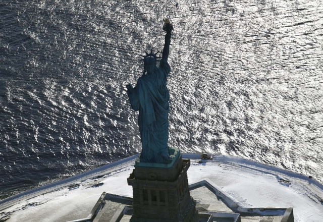 NEW YORK, NY - JANUARY 05: A snow plows next to the Statue of Liberty on January 5, 2018 in New York City. New York City dug out from the "Bomb Cyclone" under frigid temperatures.   John Moore/Getty Images/AFP