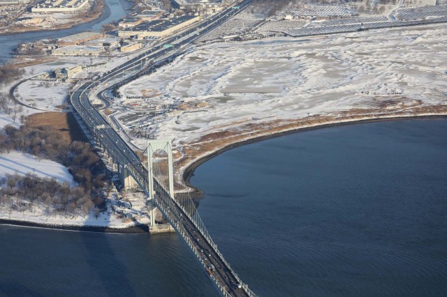 NEW YORK, NY - JANUARY 05: Traffic moves over the Bronx-Whitestone Bridge next to the snow-blanketed Trump Golf Links at Ferry Point on January 5, 2018 in the Bronx neighborhood of New York City. Under frigid temperatures, New York City dug out from the "Bomb Cyclone." John Moore/Getty Images/AFP