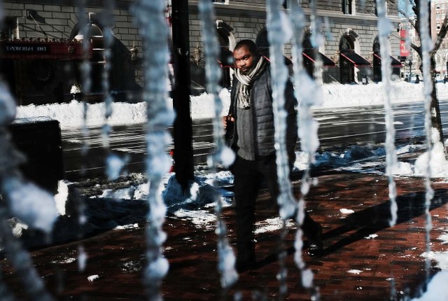 BOSTON, MA - JANUARY 05: A man is reflected in a frozen window the morning after a massive winter storm on January 5, 2018 in Boston, United States. Schools and businesses throughout the Boston area get back to work today after the city received over a foot of snow during a fast moving storm yesterday. Spencer Platt/Getty Images/AFP