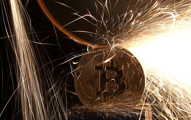 FILE PHOTO: Sparks glow from broken Bitcoin (virtual currency) coins in this illustration picture, December 8, 2017. REUTERS/Dado Ruvic/Illustration/File Photo
