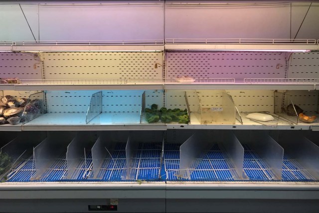 An empty refrigerator is seen at a supermarket in Caracas, Venezuela January 9, 2018. REUTERS/Marco Bello
