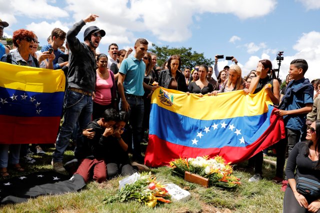 Relatives and mourners of Jose Pimentel and Abraham Agostini, part of the team of rogue ex-policeman Oscar Perez, react next to their gravesites, in Caracas, Venezuela January 20, 2018. REUTERS/Marco Bello