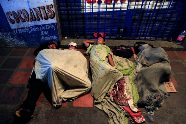 People sleep on makeshift beds, on a street, where Venezuelan migrants gather to spend the night, in Maicao, Colombia February 15, 2018. Picture taken February 15, 2018. REUTERS/Jaime Saldarriaga