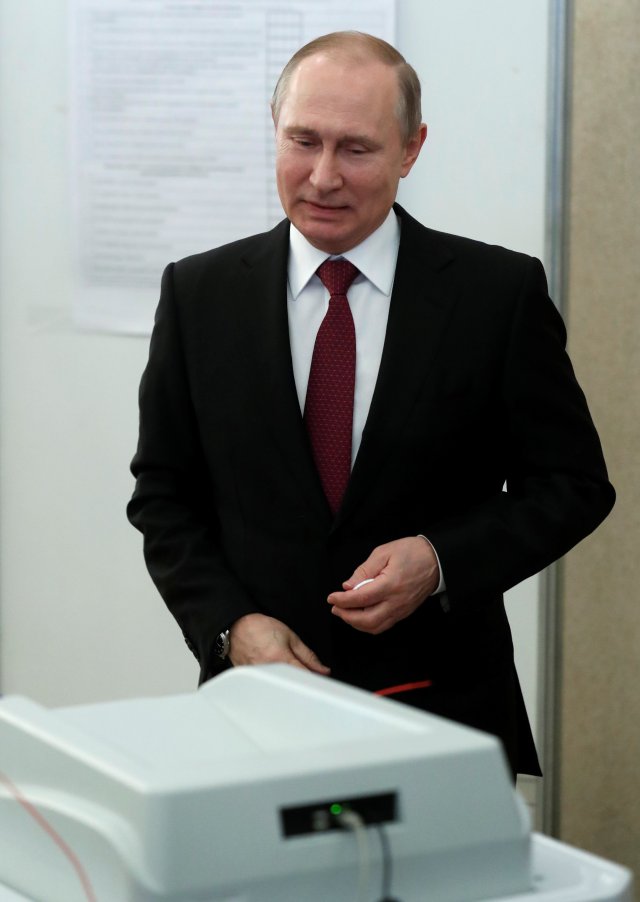 Russian President and Presidential candidate Vladimir Putin smiles after casting his ballot at a polling station during the presidential election in Moscow, Russia March 18, 2018. Sergei Chirkov/POOL via Reuters