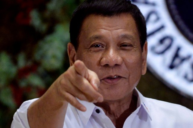  Rodrigo Duterte points to photographers during an awarding ceremony for outstanding government workers, at the Malacanang Palace in Manila, Philippines December 19, 2016. REUTERS/Ezra Acayan/File Photo