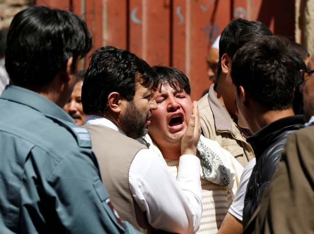 A man reacts as others comfort him at the site of a suicide attack in Kabul, Afghanistan April 22, 2018. REUTERS/Omar Sobhani